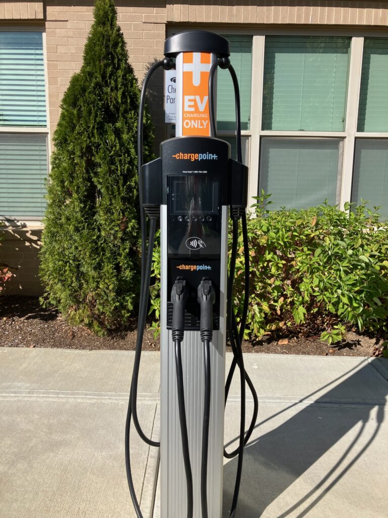 Wall-mounted EV charger and electrical setup, part of home electrical services in Pembroke, MA.