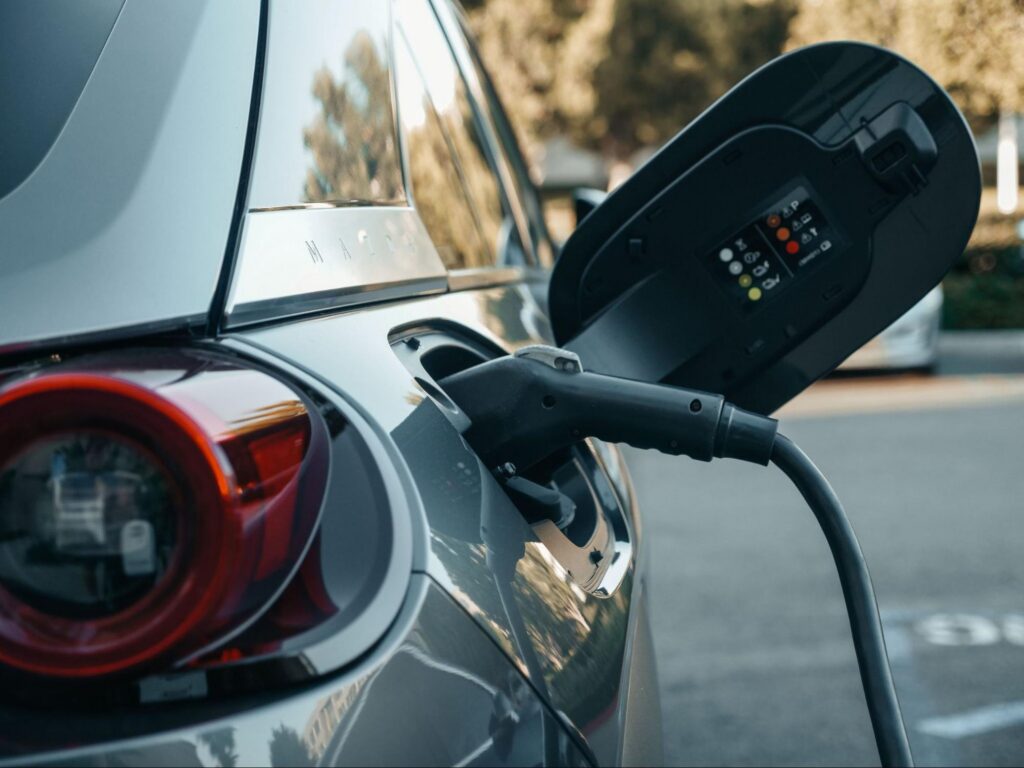 Electric car plugged in to charge, illustrating EV charging for Marshfield, MA homes.
