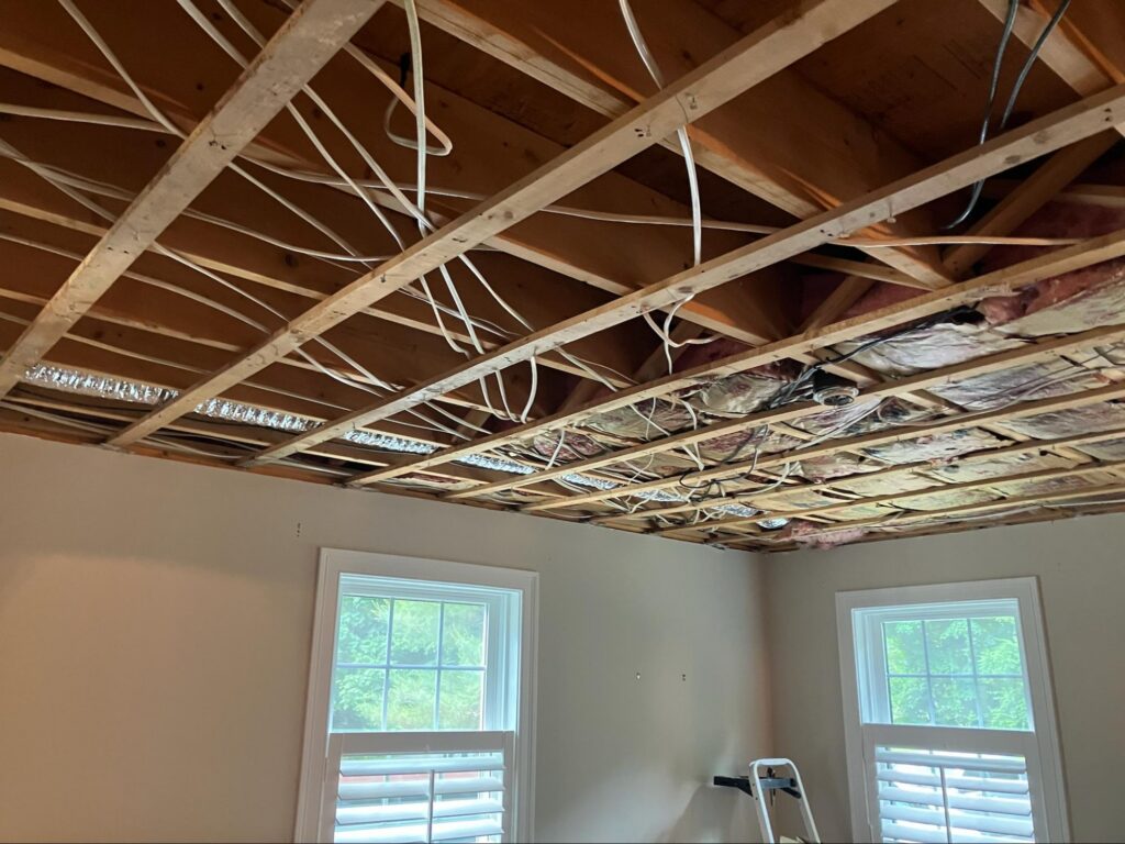 Ceiling rewiring during a renovation by a licensed electrician serving Norwell, MA.